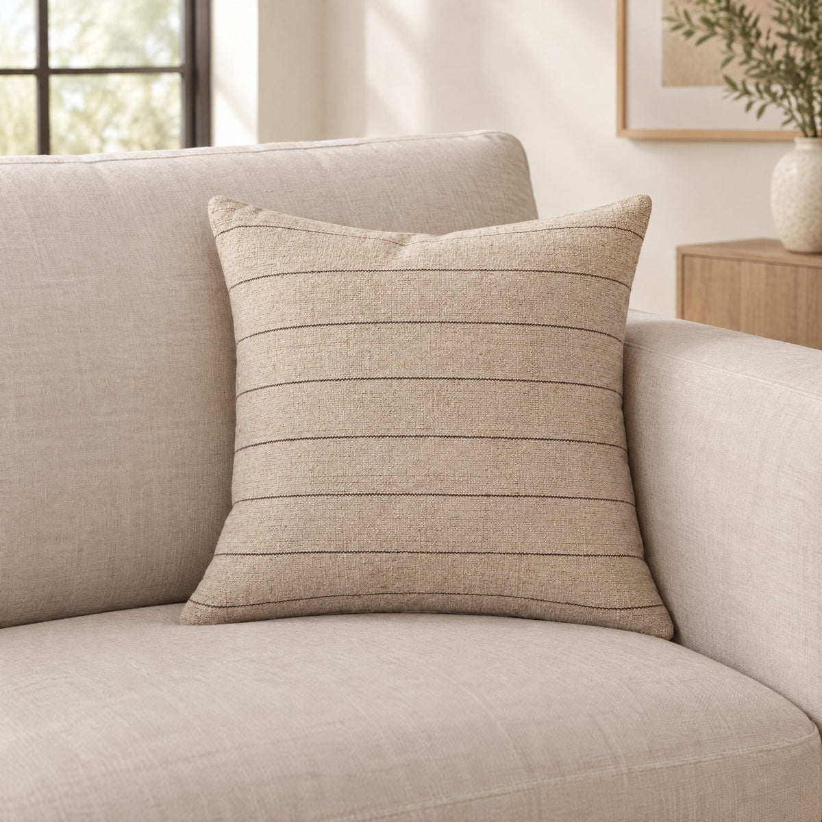 Natural and brown striped cushion on a sofa
