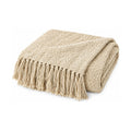 Beige knitted throw with tassels, folded product shot on a white background