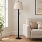 Black floor lamp beside a sofa to show its height