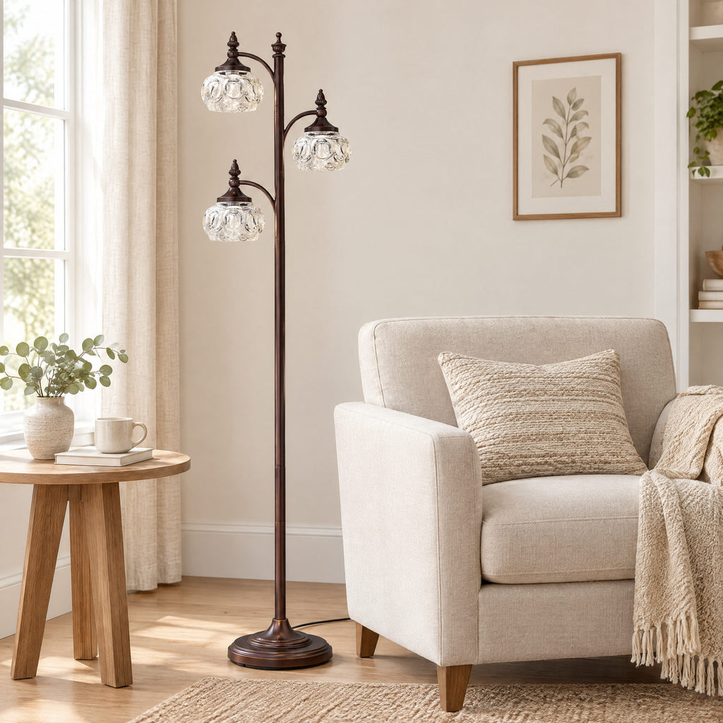 Bronze glass tree floor lamp beside a sofa to show its height