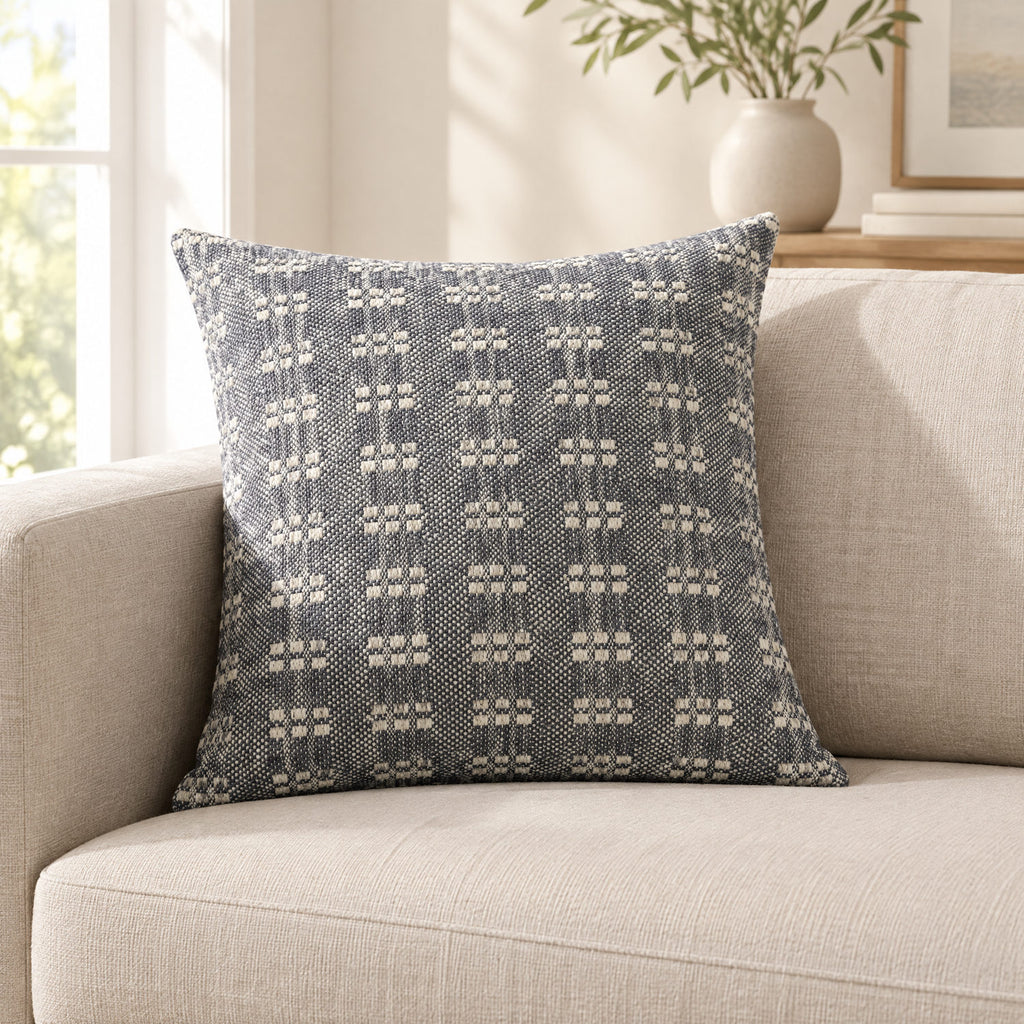 Bryn navy cushion on a sofa to show its size