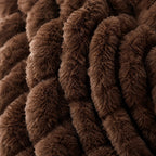 Close-up showing both sides of the chocolate reversible faux fur