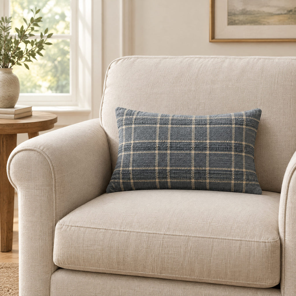 Golden and blue plaid lumbar cushion on a sofa to show its size