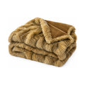 Golden faux fur and velvet throw, folded product shot on a white background