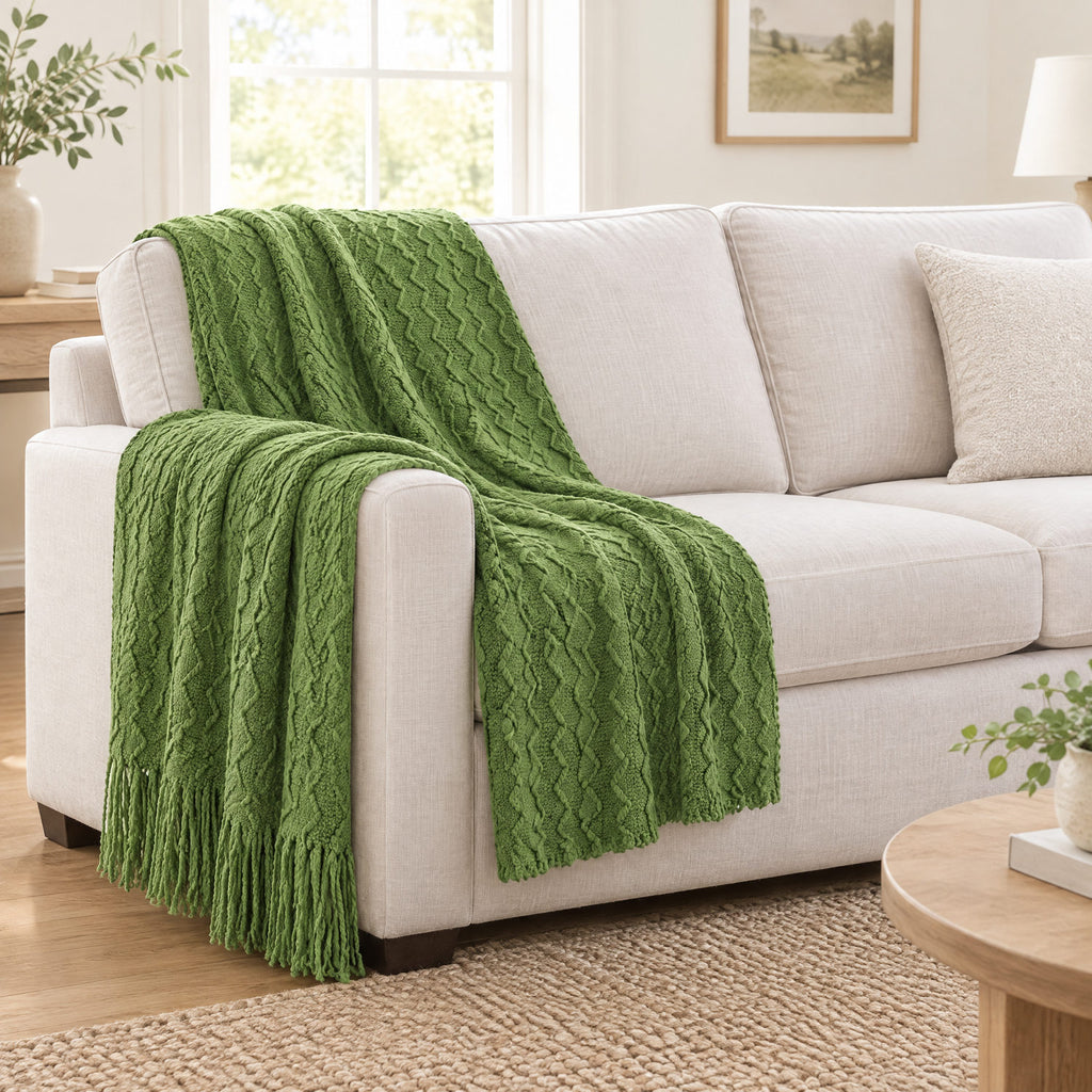 Green textured knit throw draped over a chair to show its size