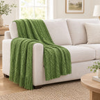Green textured knit throw draped over a chair to show its size