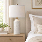 Grey ceramic table lamp on a bedside table to show its height