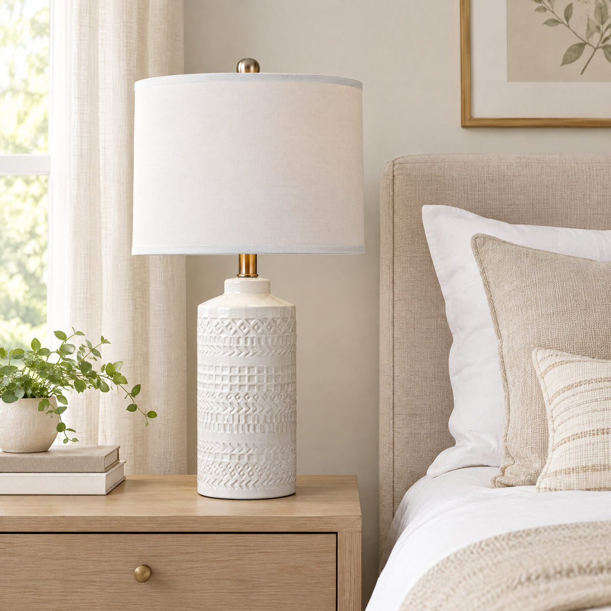 Grey ceramic table lamp on a bedside table to show its height