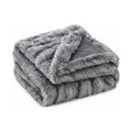 Grey faux fur throw, folded product shot on a white background
