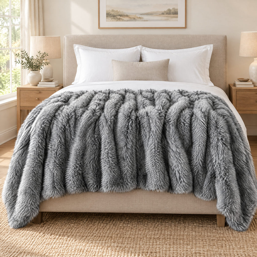 Grey faux fur throw on a sofa to show its size