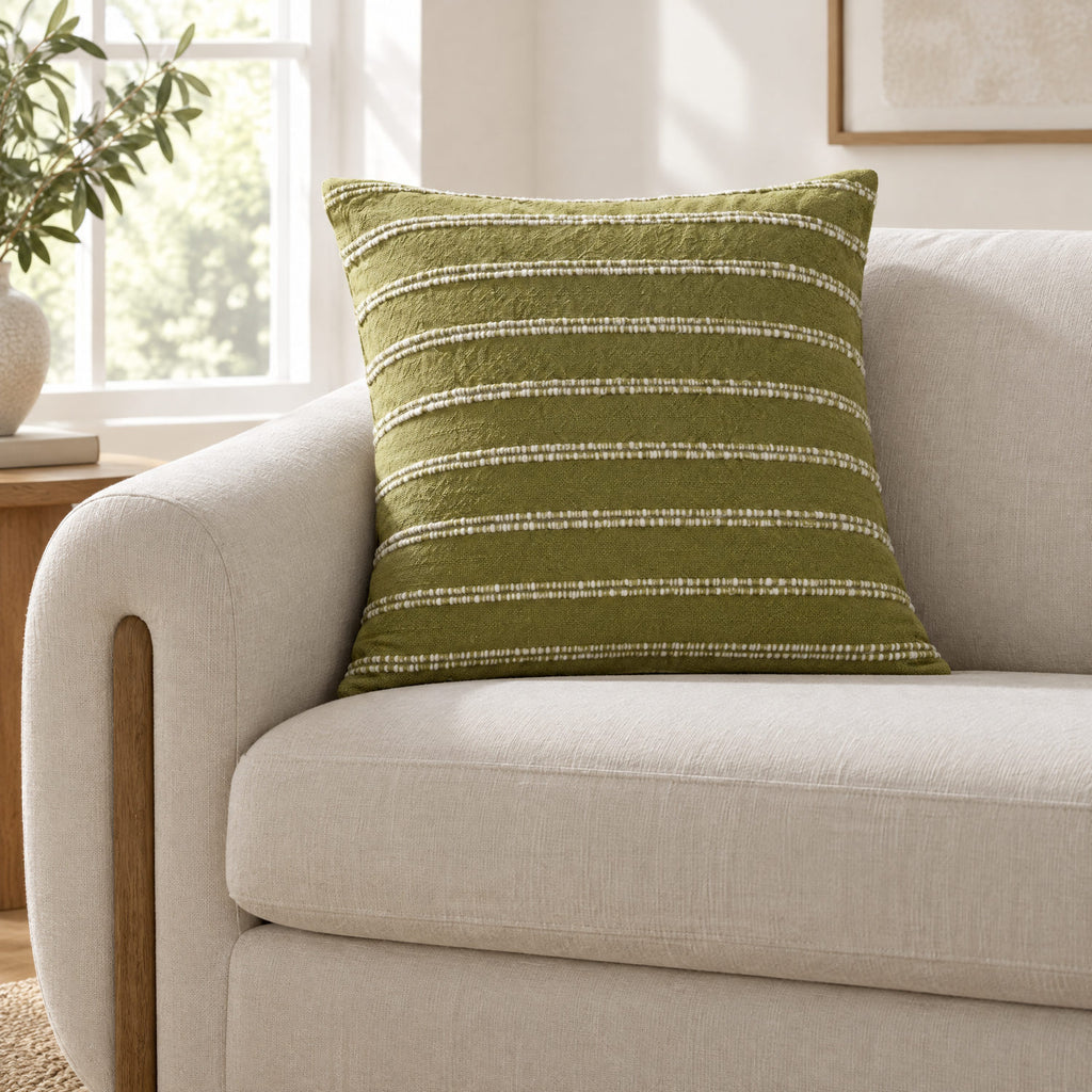 Landry green and natural cushion on a sofa to show its size