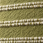 Close-up of the Landry cushion weave in green and natural