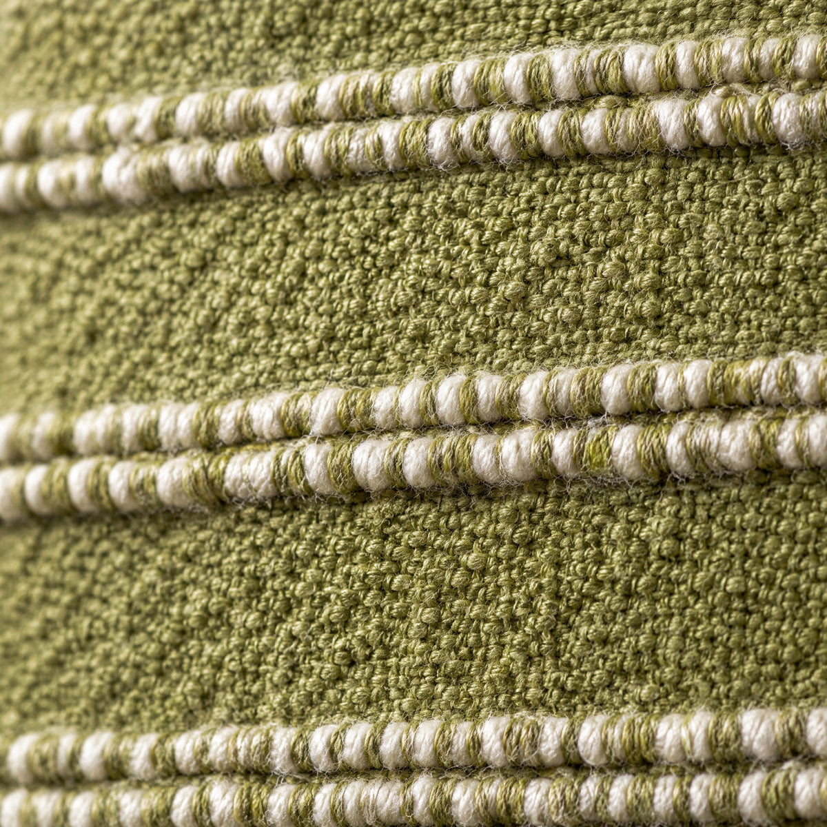 Close-up of the Landry cushion weave in green and natural