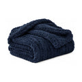 Navy chunky knit throw, folded product shot on a white background