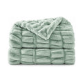 Sage green faux fur throw, folded product shot on a white background