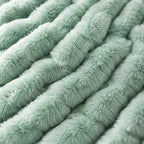 Close-up of the sage green faux fur pile