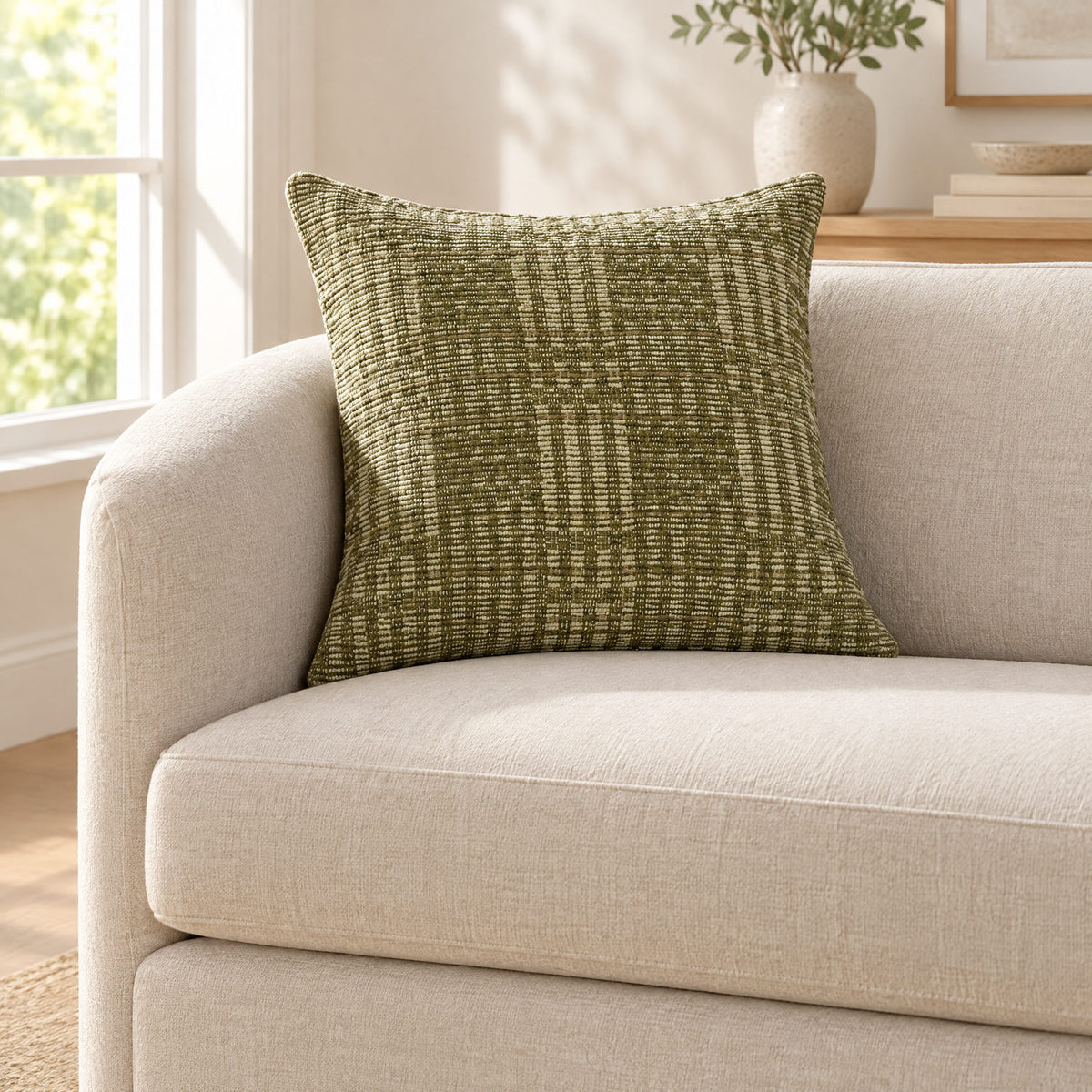 Vinnie green cushion on a sofa to show its size